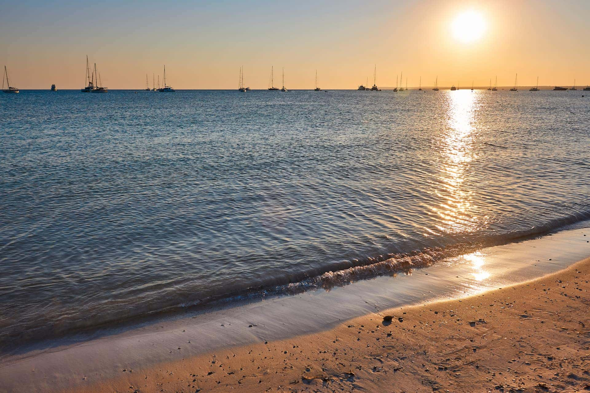 Es Trenc beach shore at sunset